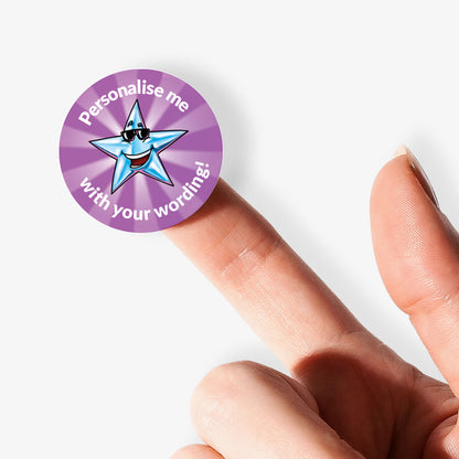 Circular purple stickers with a cartoon star and text on a white background. Single sticker being held by finger
