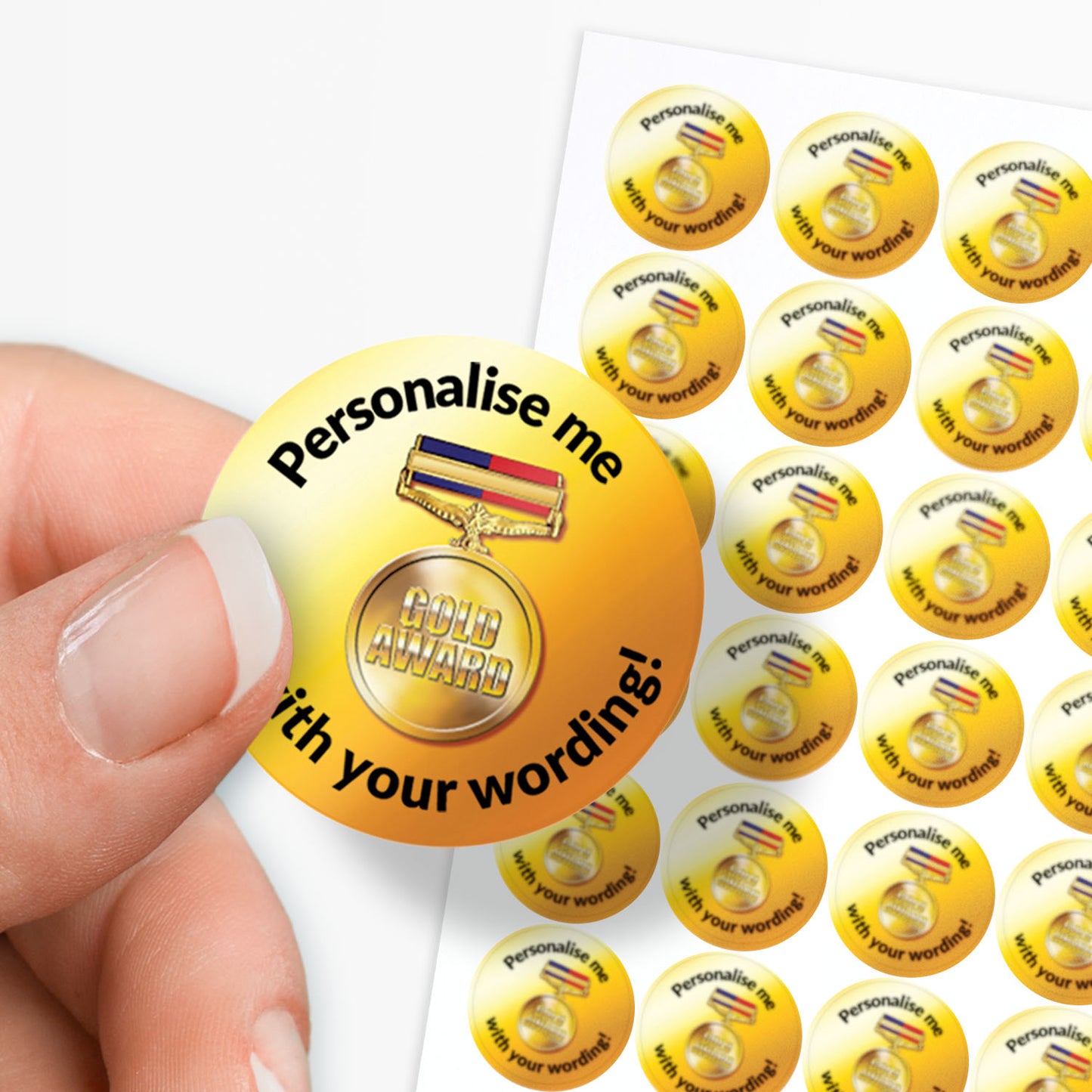 Sheet of gold stickers with personalized text on a white background held between finger and thumb