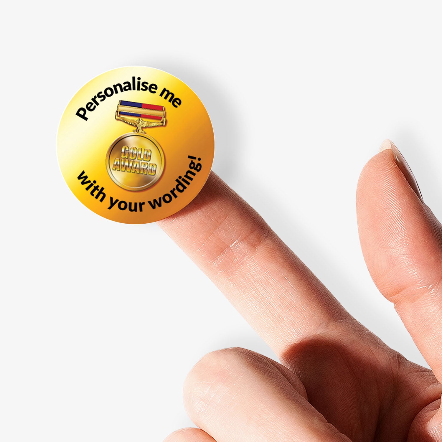 Gold sticker with personalized text on a white background held on a finger