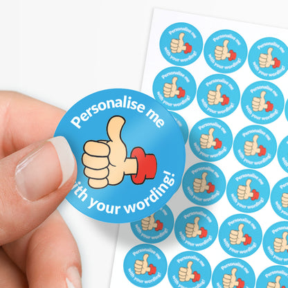 Circular sticker with a thumbs-up icon and text 'Personalise me with your wording!' held by a hand, with more stickers in the background.