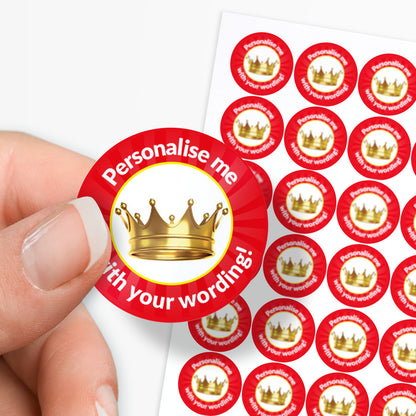 Red sticker with gold crown and text 'Personalise me with your wording!' held by a hand, with more stickers in the background.
