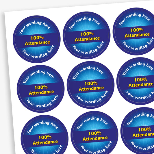 Sheet of 70 round, blue stickers, each 25mm in diameter, featuring bold yellow text reading '100% Attendance' at the centre. Surrounding the central text is placeholder wording 'Your wording here' above and below, indicating customisable areas for personalised messages.
