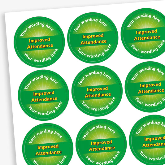 Sheet of 70 personalised 'Improved Attendance' stickers from Primary Teaching Services, each 25mm in diameter, featuring a green circular design with the text 'Improved Attendance' in bold yellow letters and space for custom wording above and below, ideal for recognising pupils' attendance improvements.