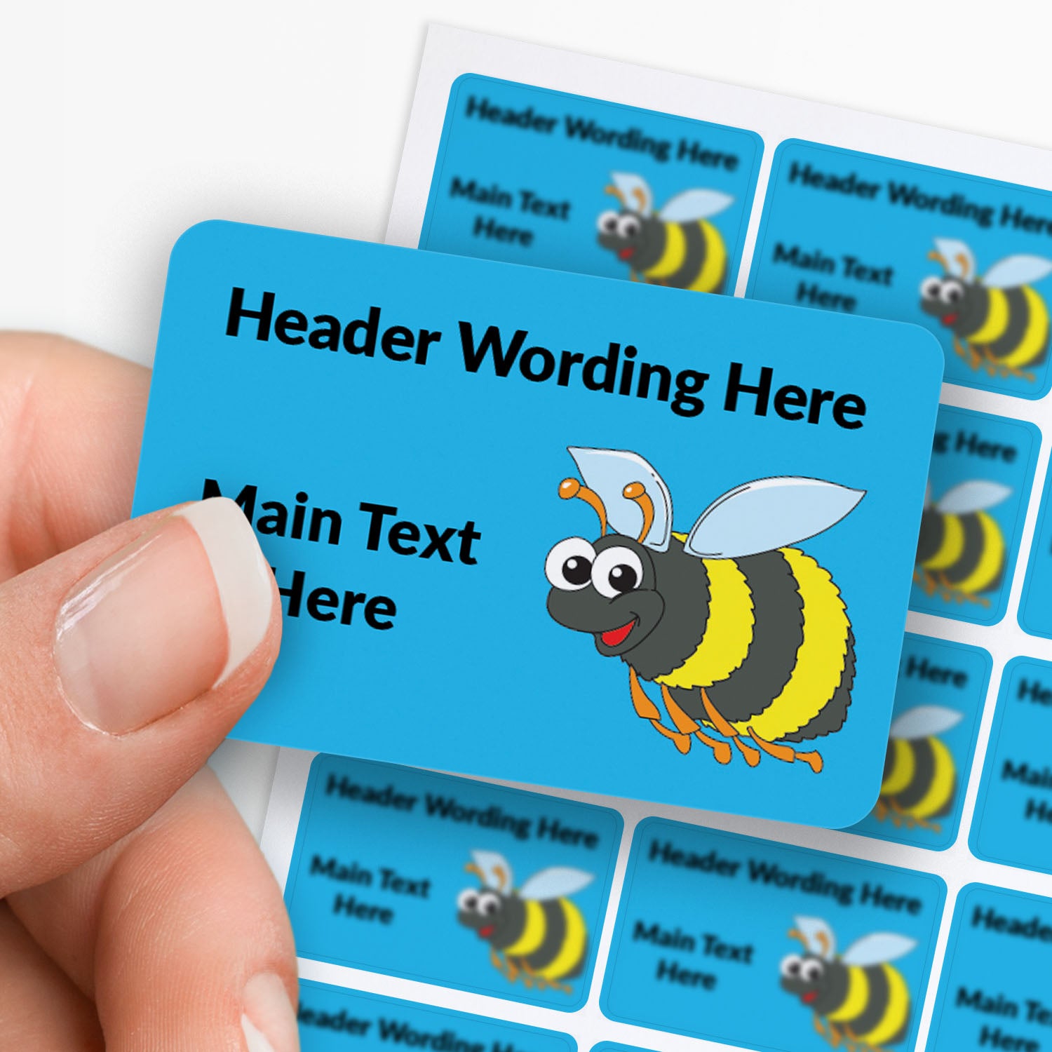 Sheet of rectangle blue sticker with bee decals and text. Single sticker held between finger and thumb