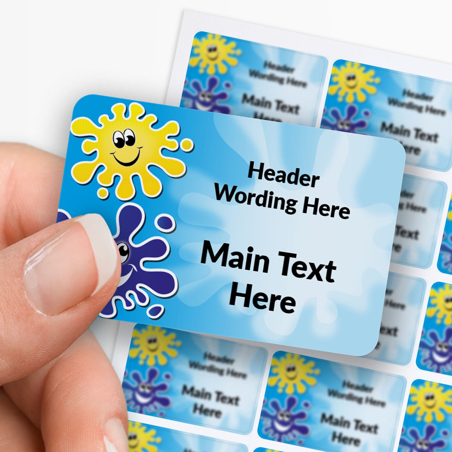 Sheet of rectangle blue sticker with splat decals and text. single sticker held between finger and thumb