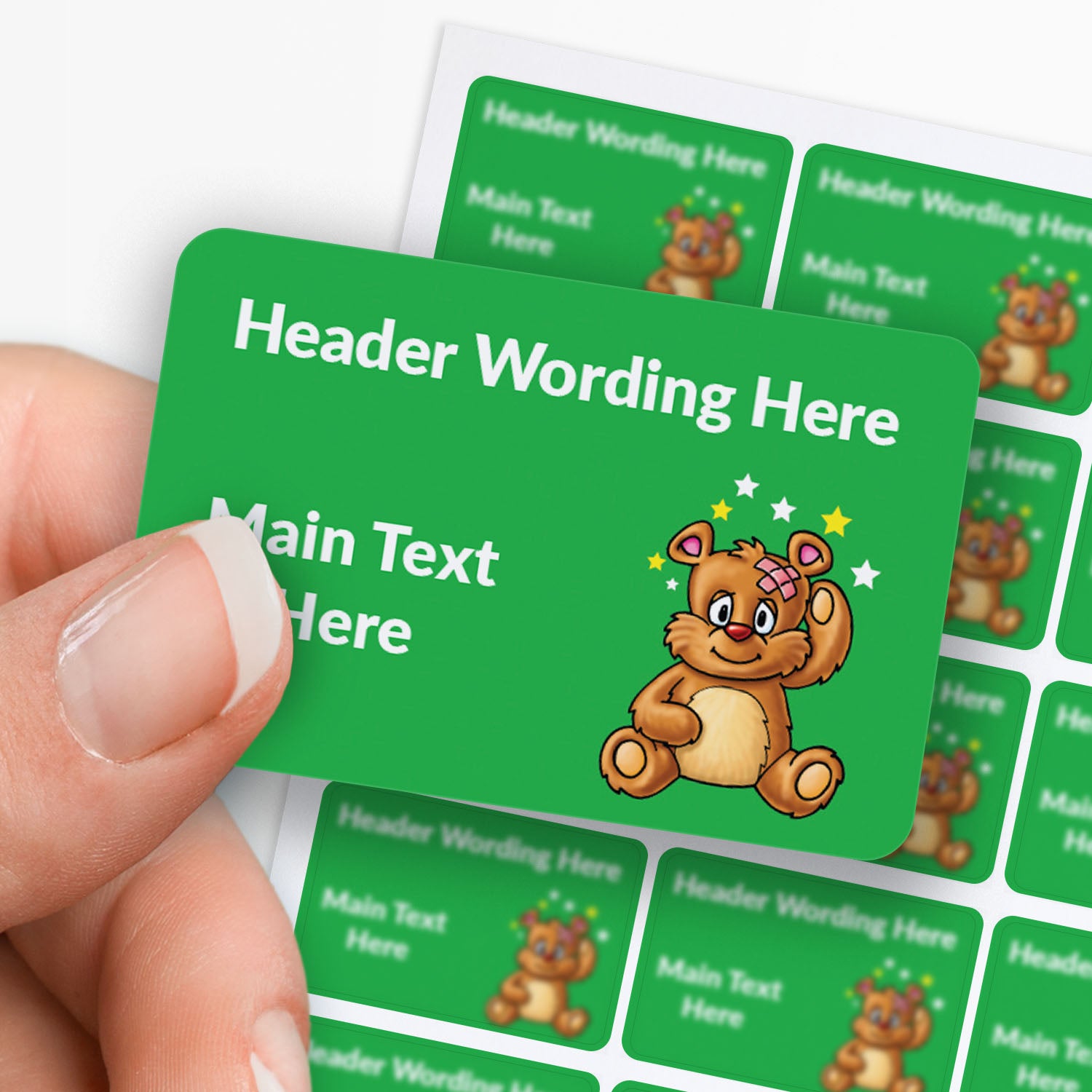 Green label with cartoon bear and customisable text, held by a hand.