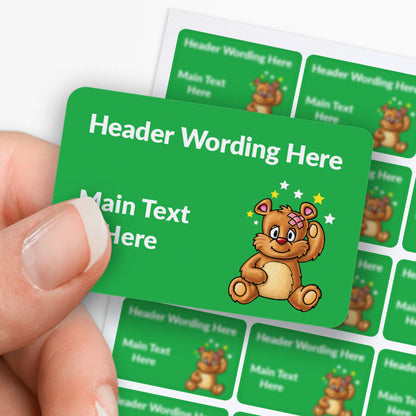 Green label with cartoon bear and customisable text, held by a hand.