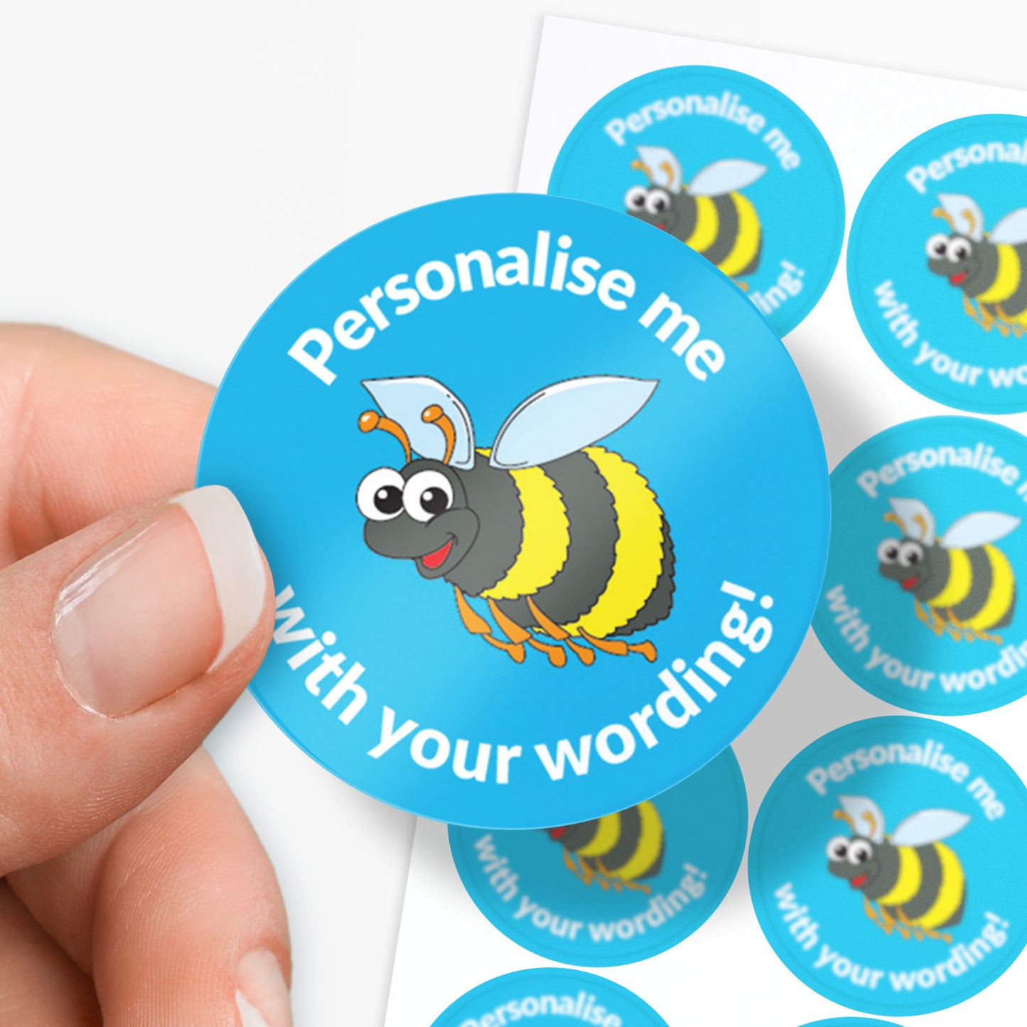 Blue sticker with a bumble bee central with 'Personalise me' above and 'with your wording' below on a finger