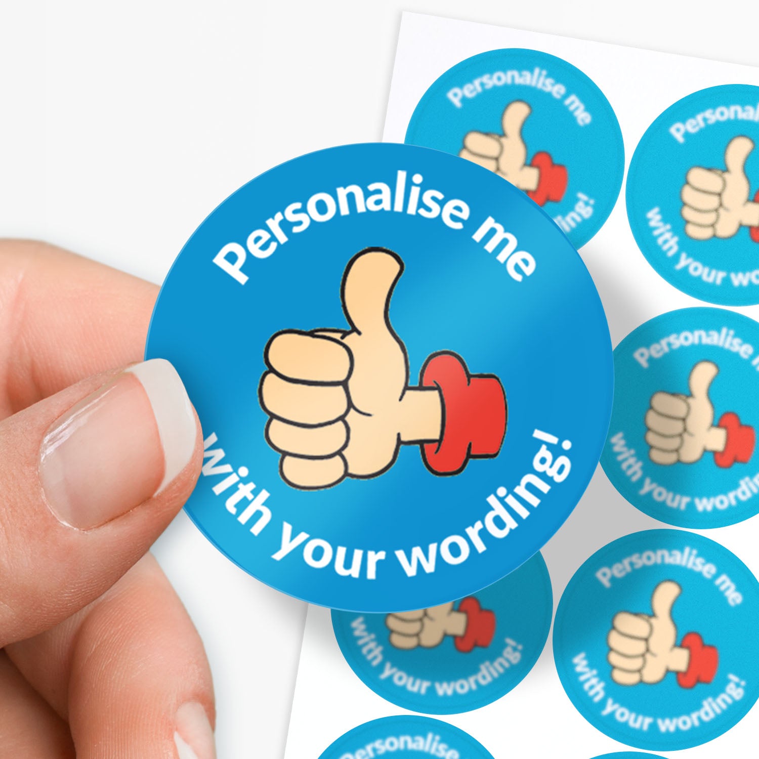 Circular blue sticker with a thumbs-up icon and text 'Personalise me with your wording!' held by a hand.