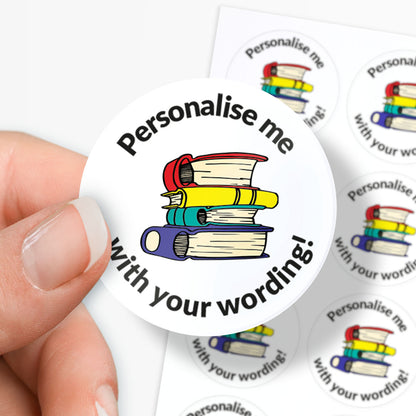 Round sticker with books and text 'Personalise me with your wording!' held by a hand.