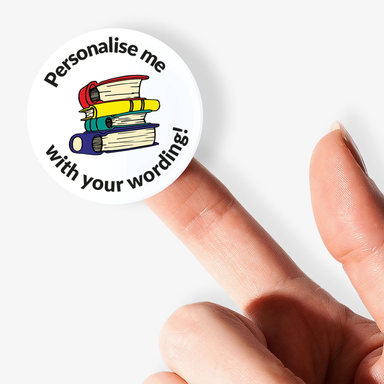 Round sticker with books and text 'Personalise me with your wording!' held by a finger on a white background
