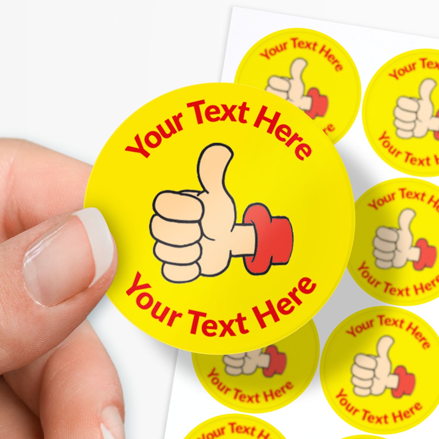 Yellow stickers with a thumbs-up icon and 'Your Text Here' text, held by a hand.