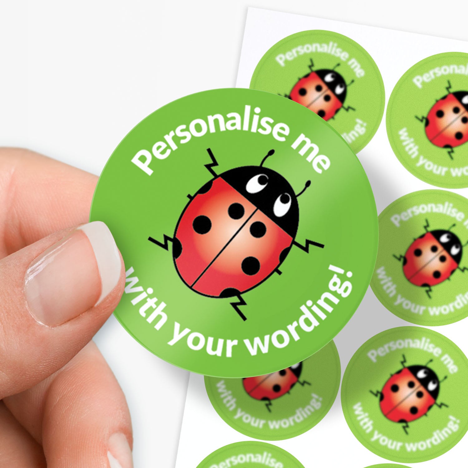 Green stickers with ladybug design and text 'Personalise me with your wording!' held by a hand.