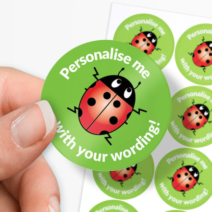 Green stickers with ladybug design and text 'Personalise me with your wording!' held by a hand.