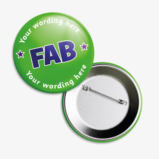A set of ten 38mm round badges with a vibrant green background, featuring the word "FAB" in bold purple capital letters at the centre; customisable white text areas are positioned above and below the central design, and the badge includes a safety pin backing.
