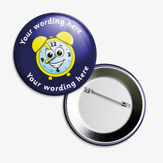 A set of ten 38mm round badge with a dark blue background, featuring a cheerful cartoon clock face with yellow bells and a smiling expression at the centre; customisable white text areas are positioned above and below the central design, and the badge includes a safety pin backing.
