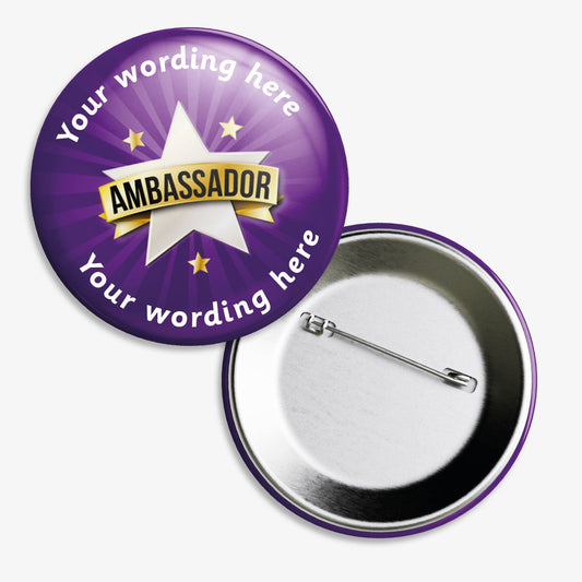 Set of ten 50mm round personalised badges featuring a silver star with AMBASSADOR embossed on it on a deep purple starburst background; includes customisable white text above and below the image equipped with safety pin fastenings
