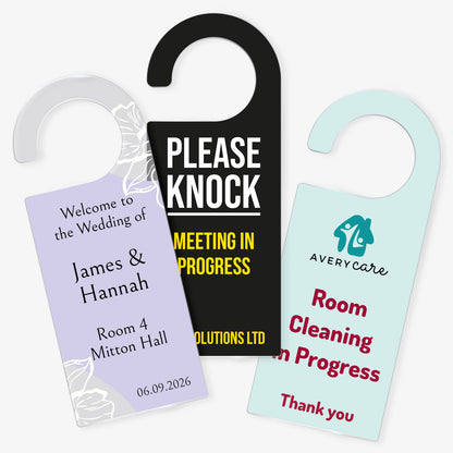 Three Acrylic Door Hangers left design ornate purple wedding design for 'James & Hannah', Middle design 'Please Knock Meeting In Progress on black background, right door hanger ' Room Cleaning in Progress' on a pale teal background