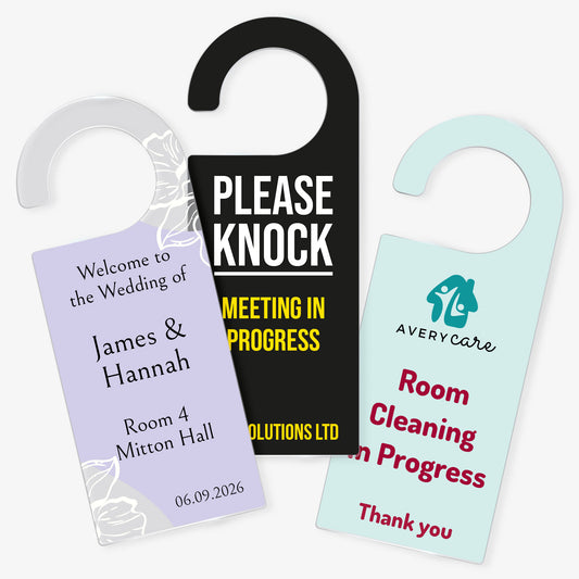 Three Acrylic Door Hangers left design ornate purple wedding design for 'James & Hannah', Middle design 'Please Knock Meeting In Progress on black background, right door hanger ' Room Cleaning in Progress' on a pale teal background