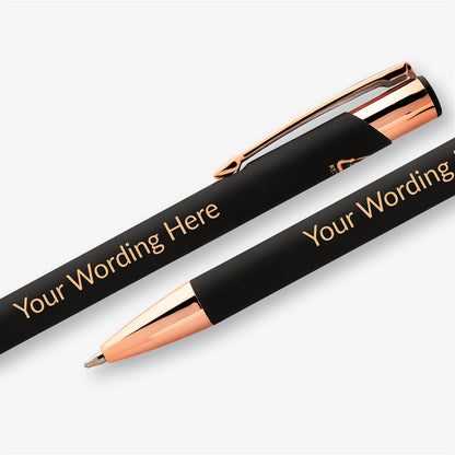 Close-up of a black personalised pen with rose gold trim and engraved wording shown across two angled views.