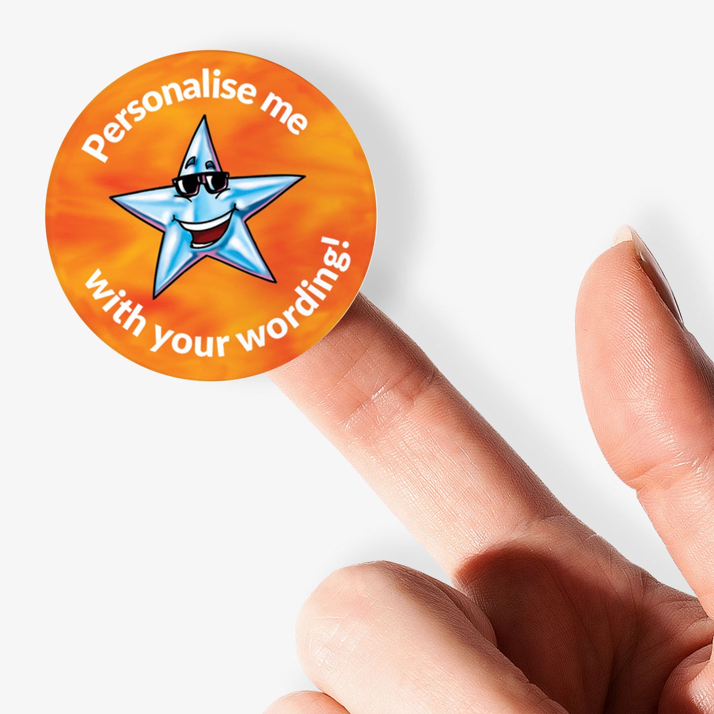 Round sticker with a star design and text 'Personalise me with your wording!' held by a finger.