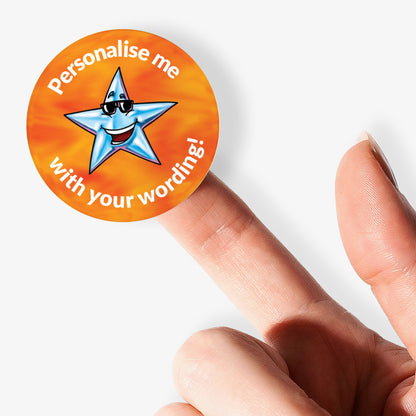 Round sticker with a star design and text 'Personalise me with your wording!' held by a finger.
