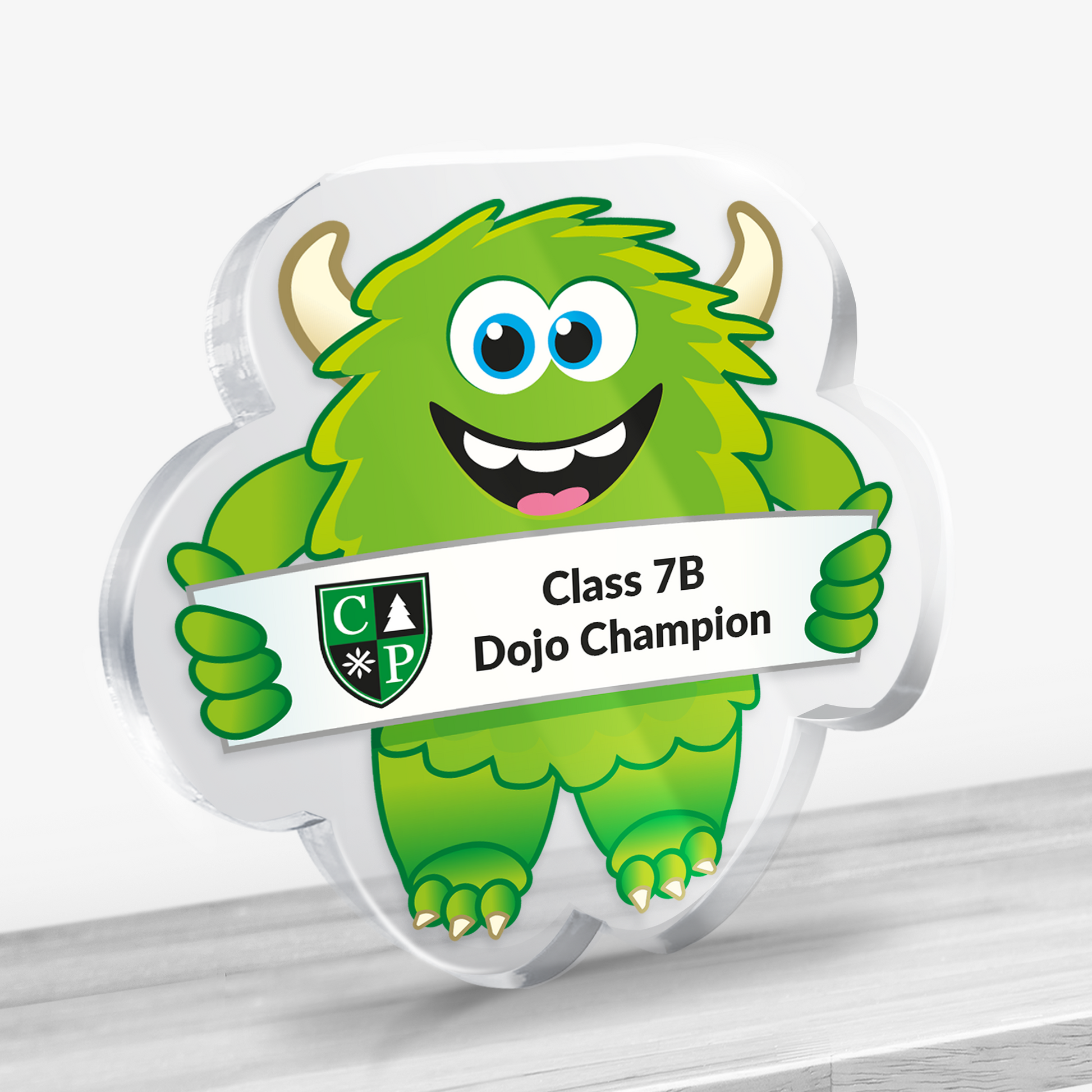 Acrylic green monster design award with example text: Class 7B Dojo Champion. Shown on a light background.