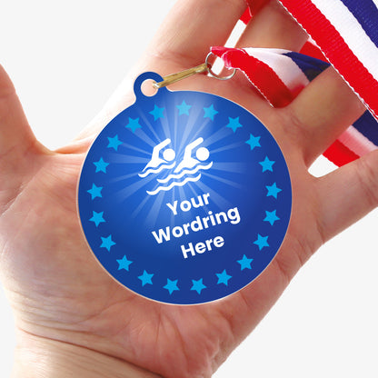 Acrylic personalised medal with stripy ribbon, in a hand, showing blue design with blue stars, swimming icon and personalised wording.