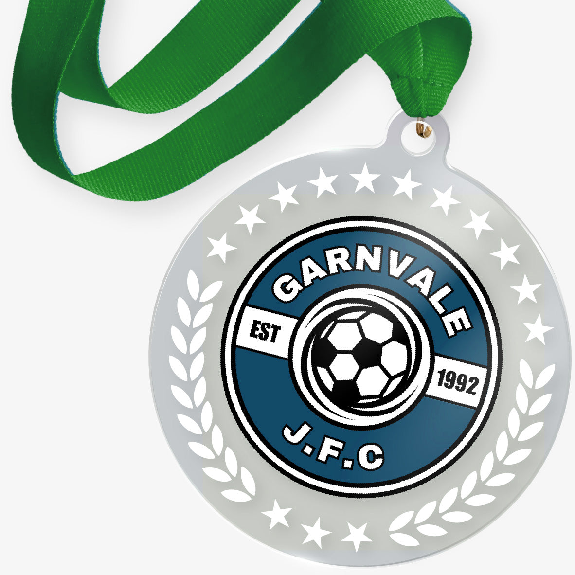 Acrylic medal with 'Garnvale J.F.C.' logo and green ribbon on a white background