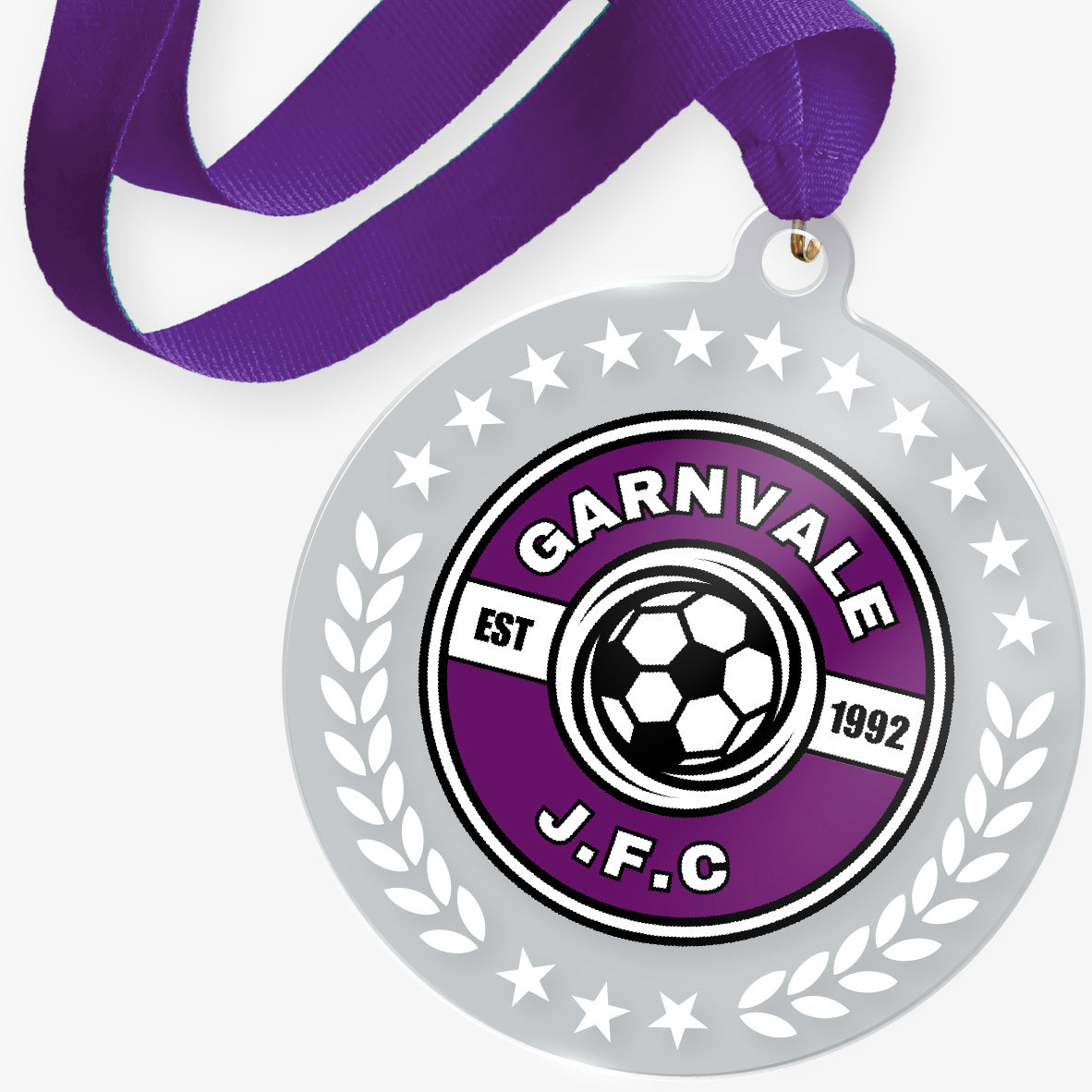 Medal with a purple ribbon featuring the 'Garnvale J.F.C.' logo on a white background.