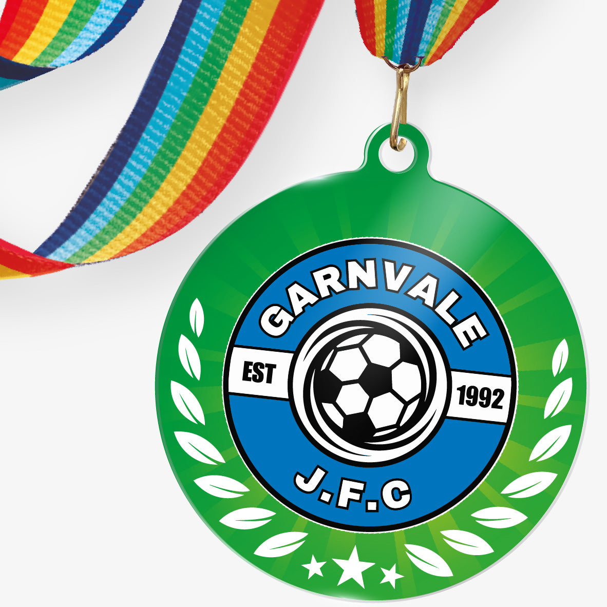 Acrylic personalised medal with rainbow ribbon showing green background with wreath design and 'Garnvale JFC' logo.