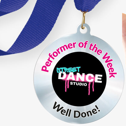 Acrylic personalised medal with blue ribbon showing silver design with 'Street Dance Studio image' and 'Performer of the Week', 'Well done!' wording.