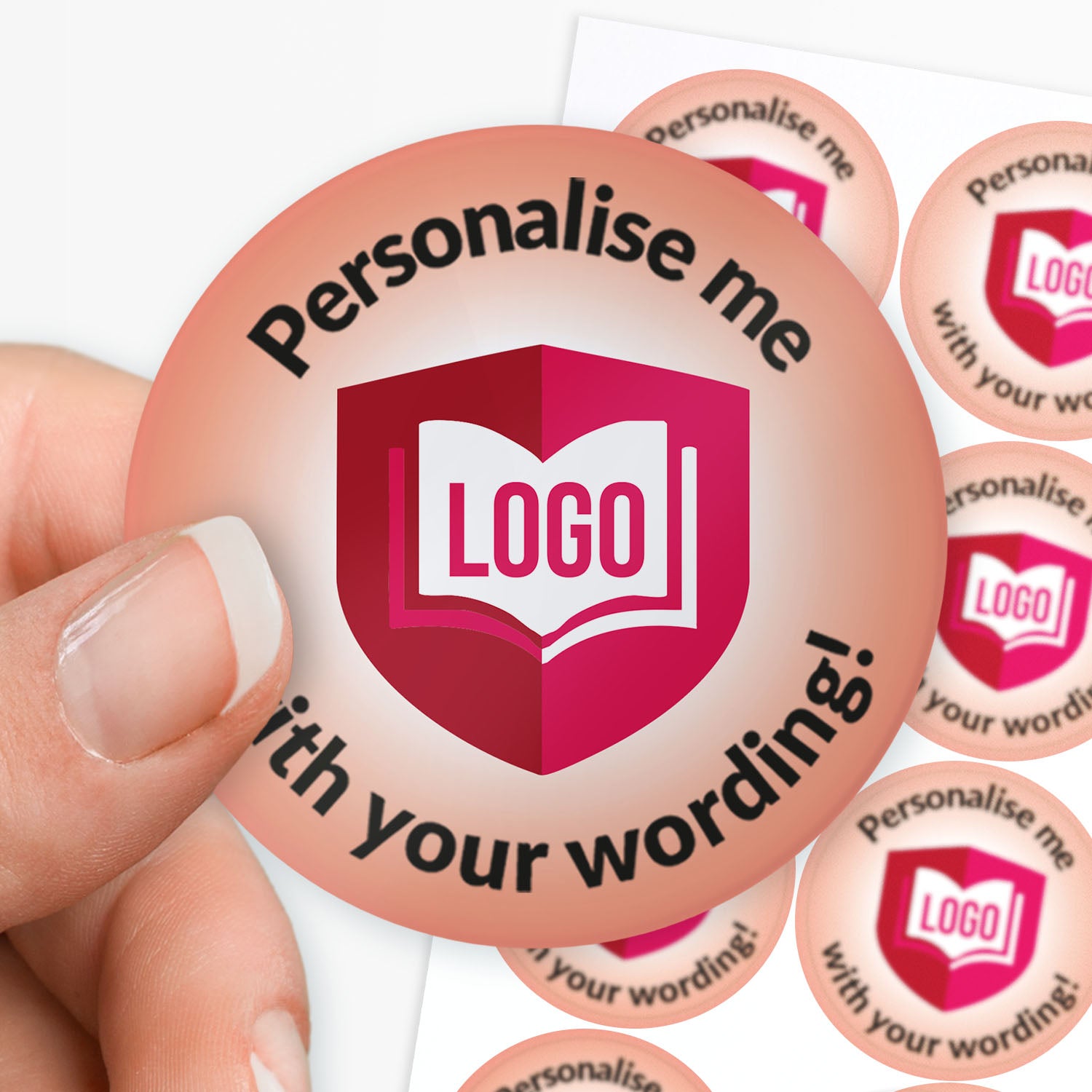 Round customizable sticker with 'Personalise me' text and a logo placeholder, held by a hand.
