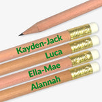 Four pencils with personalised names in green on a grey background