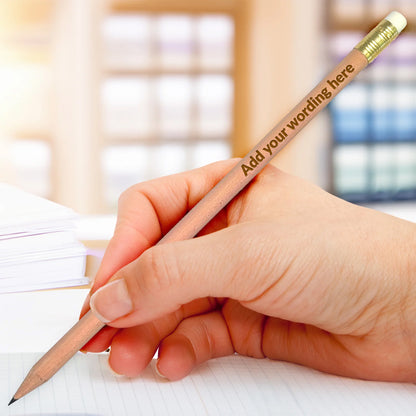 Personalised pencil with natural wooden barrel and gold ferrule. Choice of wording etched onto pencil. Shown in hand.