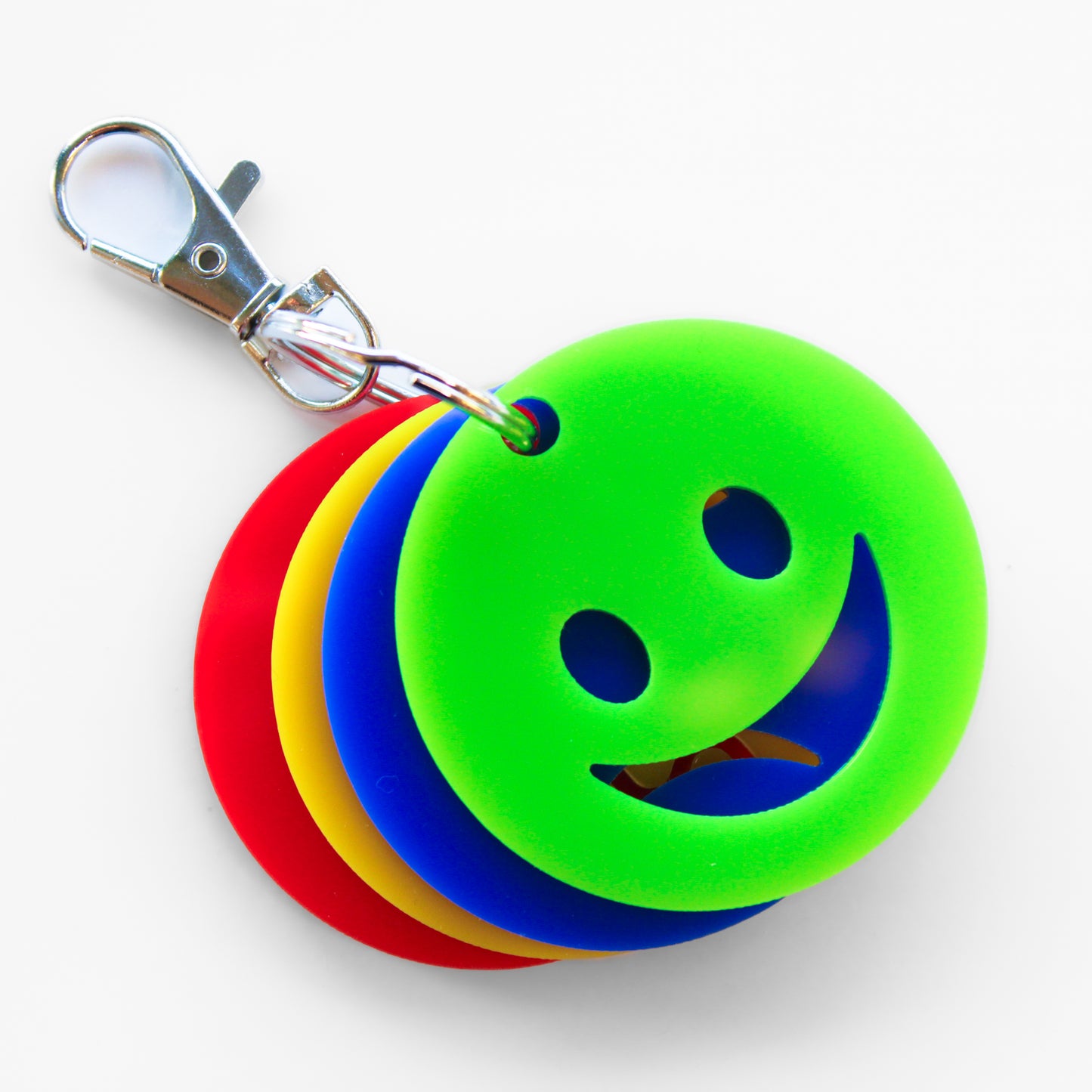 Keyring with four faces showing different emotions. Green happy face at the front.