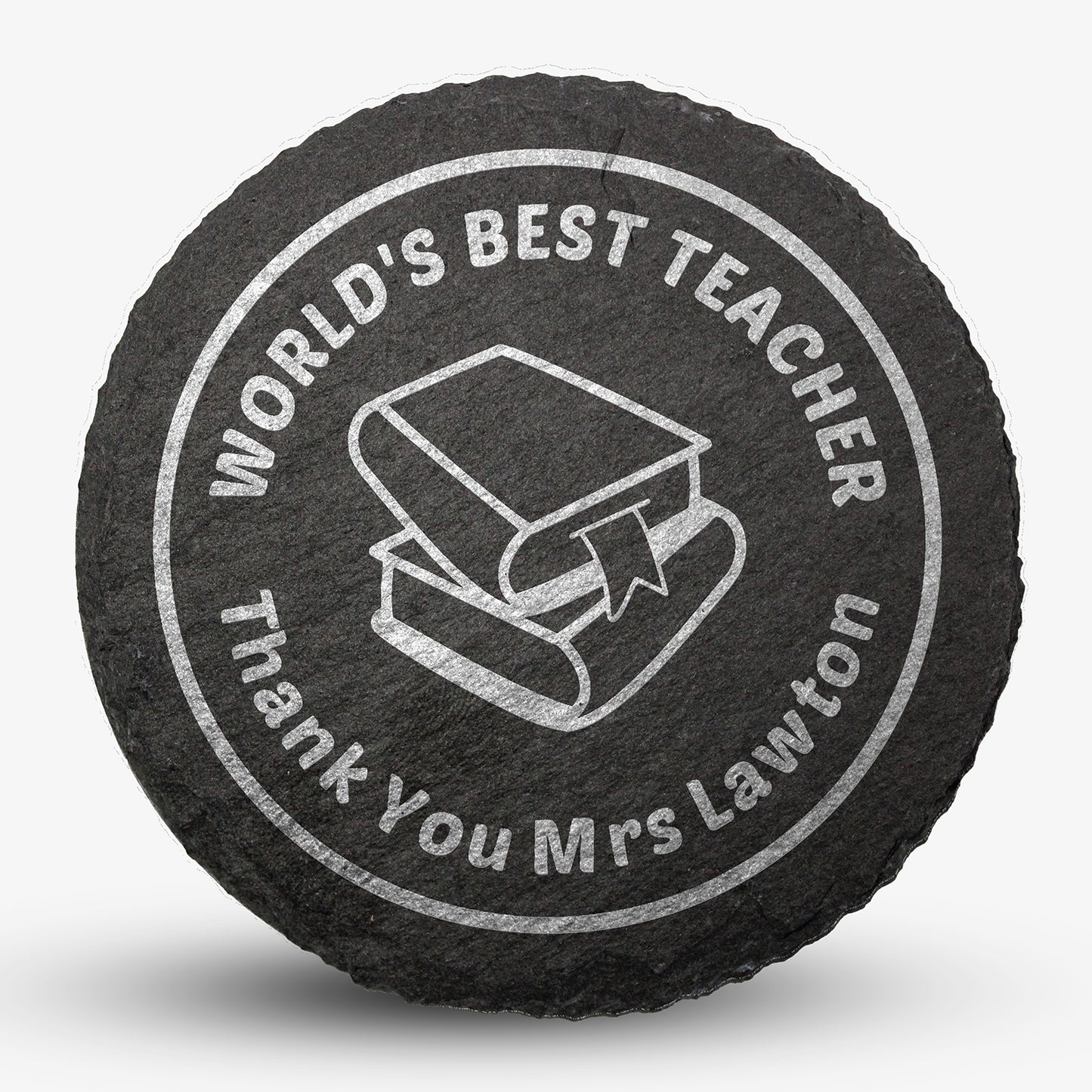 Round black slate drinks coaster with engraved placeholder text reading 'WORLD'S BEST TEACHER', Thank You Mrs Lawton', image of two text books stacked on each other, designed for personalisation.