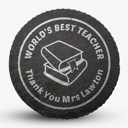 Round black slate drinks coaster with engraved placeholder text reading 'WORLD'S BEST TEACHER', Thank You Mrs Lawton', image of two text books stacked on each other, designed for personalisation.
