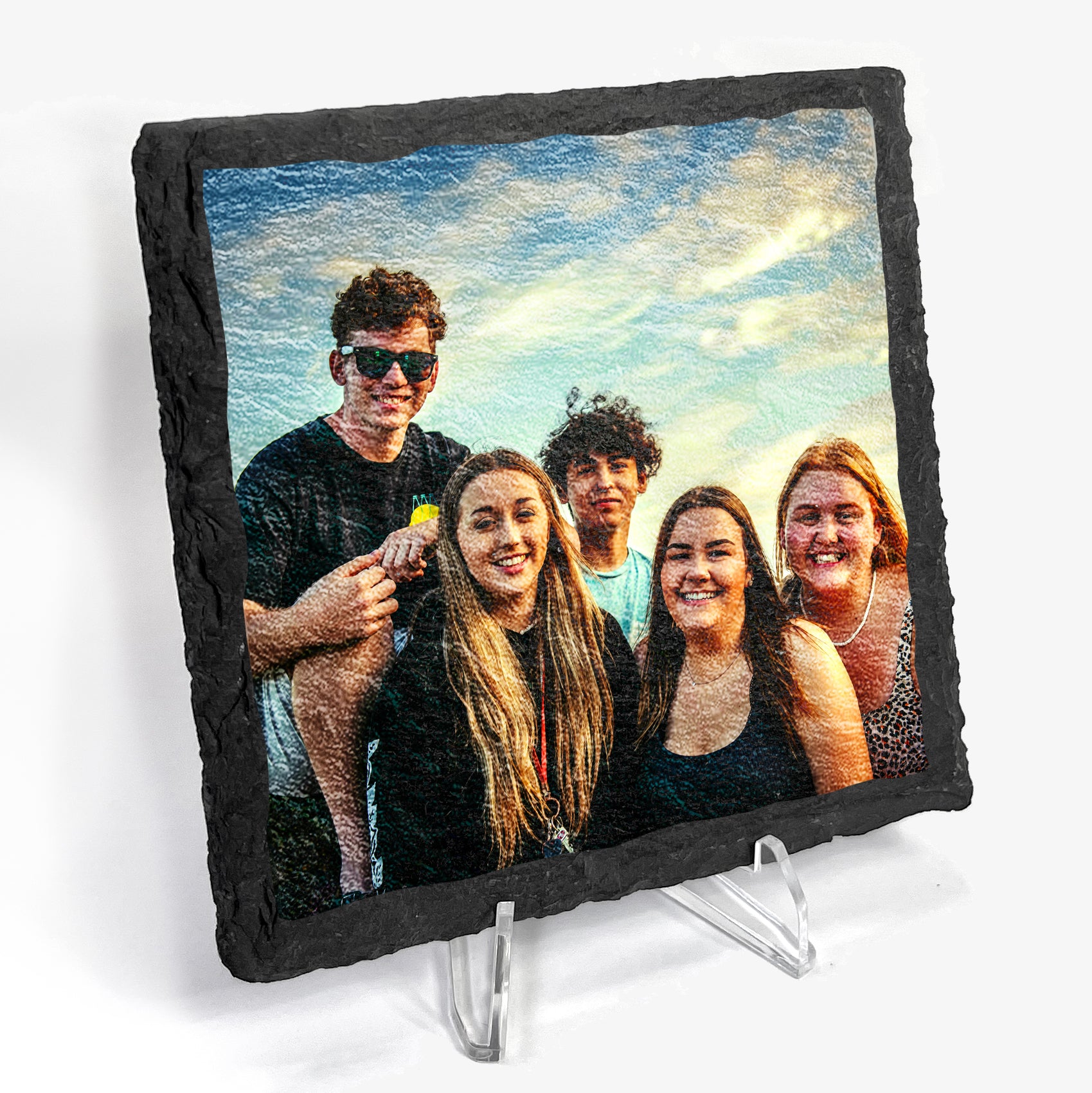 Personalized slate photo coaster showing a group of five people outdoors. Displayed on plastic stand.