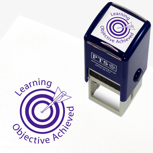 A 25mm round pre-inked teacher stamper with purple ink, featuring a central design of a target with an arrow hitting the bullseye, accompanied by the text 'Learning Objective Achieved' in a clear, bold font.
