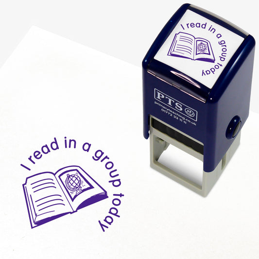 25mm self-inking stamper with purple ink, featuring the phrase 'I read in a group today' in a curved font above an open book illustration with a globe;  ideal for marking pupils' reading records.
