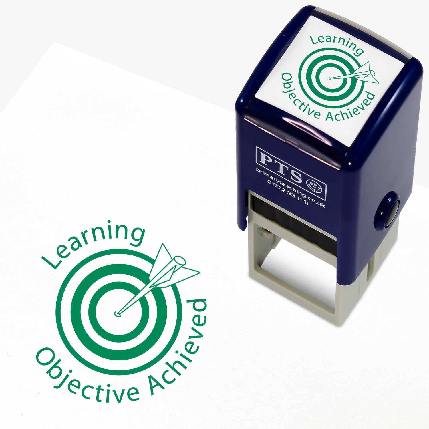 A 25mm round pre-inked teacher stamper with green ink, featuring a central design of a target with an arrow hitting the bullseye, accompanied by the text 'Learning Objective Achieved' in a clear, bold font.
