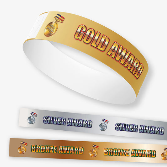 Gold, silver, and bronze award wristbands on a white background