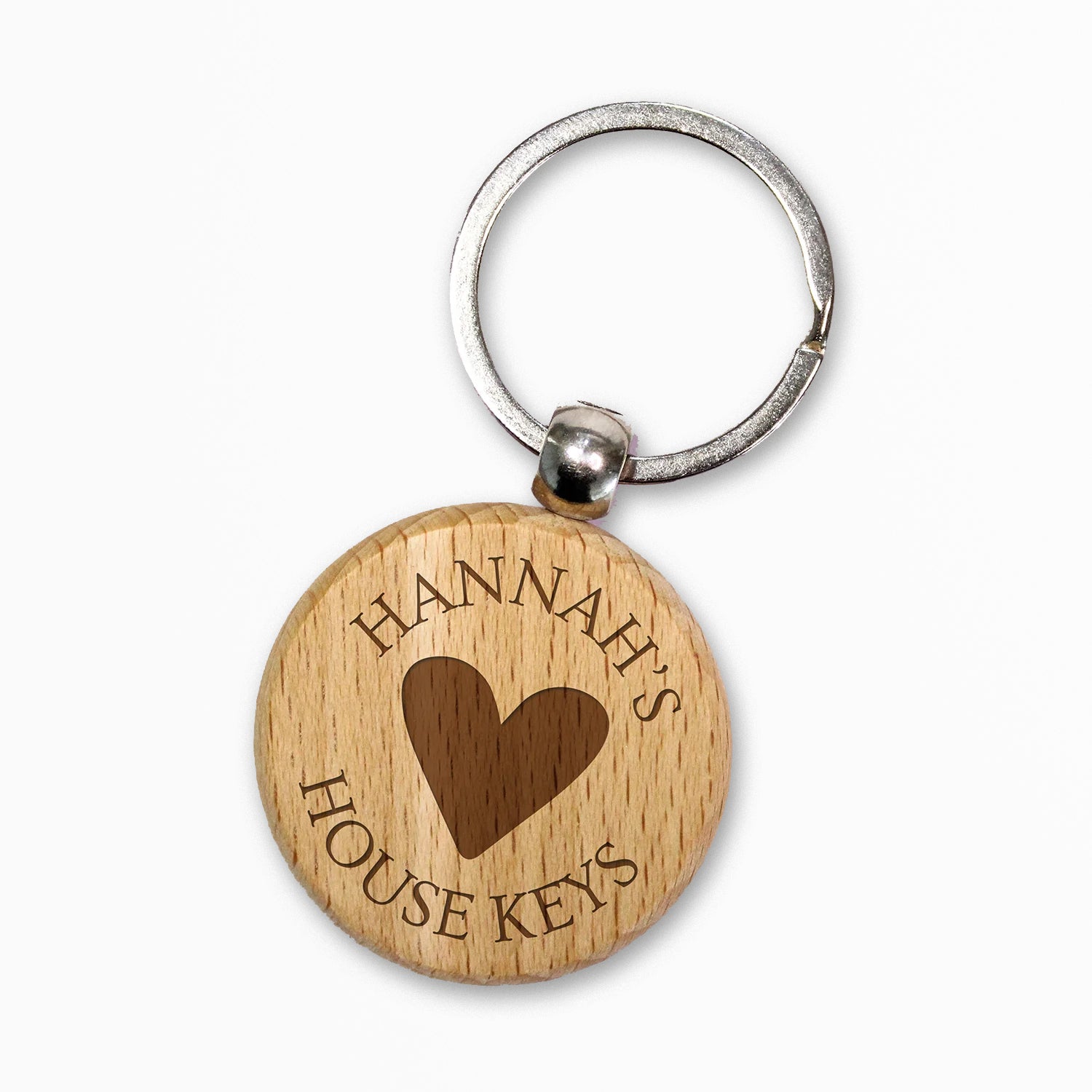 Circular wooden keyring with a metal ring, engraved with text for customisation saying 'Hannah's' a central image of a heart etched and underneath 'House Keys' 