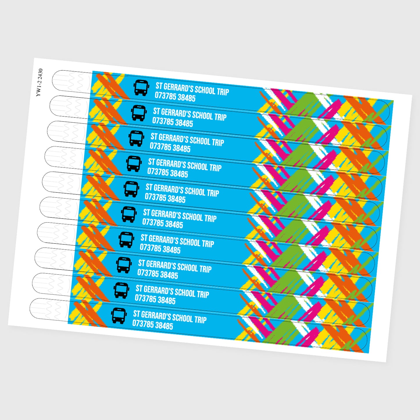 Example product of 10 wristbands laid up on a sheet of A4 paper. Includes brushstroke design background, bus icon in black, with white text, 'St Gerrard's School trip 073785 38485.
