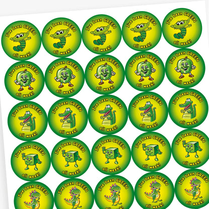 Pack of 280 37mm apple-scented circular stickers featuring vibrant green backgrounds with cheerful characters—such as a smiling apple, star, dinosaur, and alien—each displaying the text 'I've been GREEN all week!'; designed to reward positive behaviour in line with the 'Good to be Green' scheme.