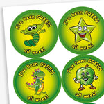 Sheet of 37mm apple-scented circular stickers featuring vibrant green backgrounds with cheerful characters—such as a smiling apple, star, dinosaur, and alien—each displaying the text 'I've been GREEN all week!'; designed to reward positive behaviour in line with the 'Good to be Green' scheme.