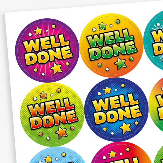 Close-up view of colourful circular Well Done reward stickers with bright comic-style star designs for pupils