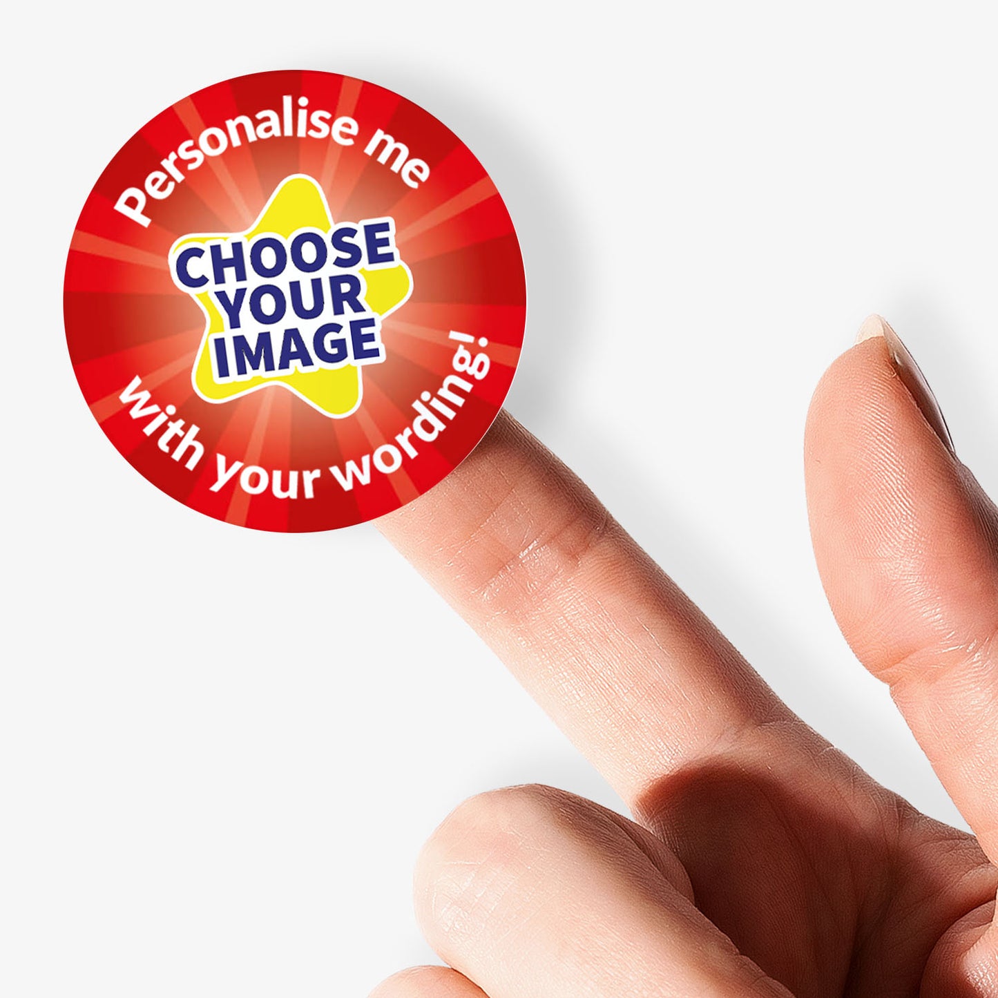 Round customisable sticker with text 'Personalise me, choose your image with your wording!' held by a finger.