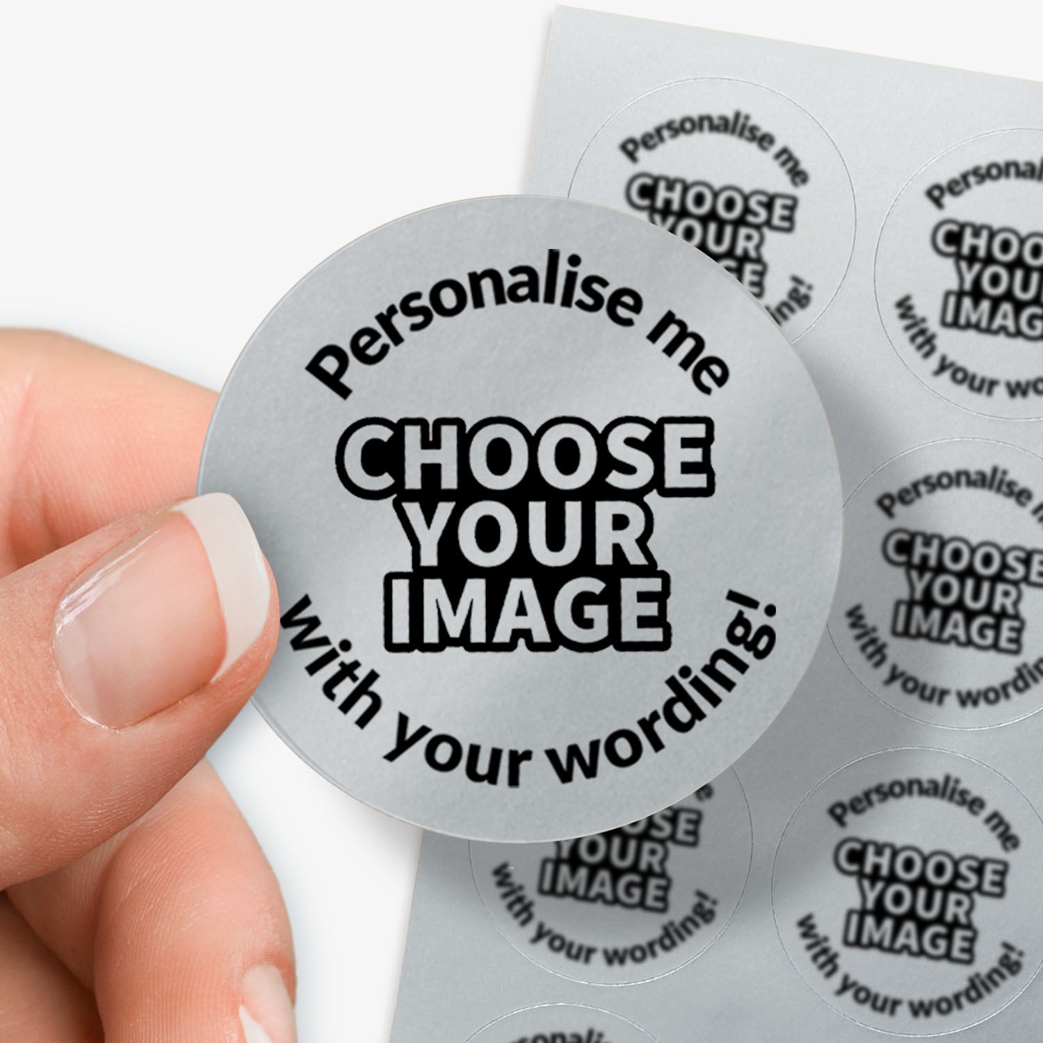 Round gray sticker with text 'Personalise me, choose your image with your wording!' held by a hand.